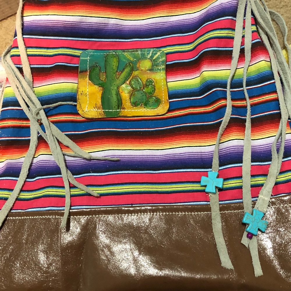Handmade bag with handtooled patch design.
